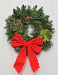 small sixteen inch wreath, round, with yellow cedars, pinecones, juniper berries and red bow